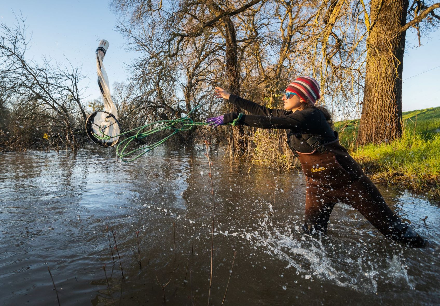 Person throwing net in river
