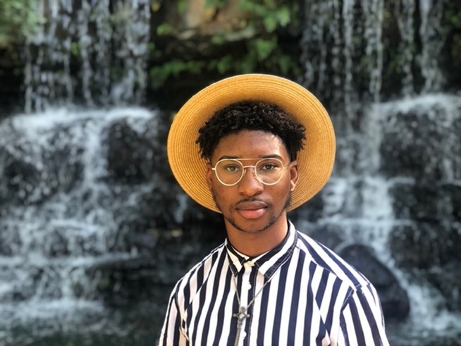 Darius Waiters in striped shirt and hat