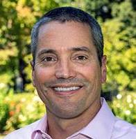 Secretary Wade Crowfoot headshot in front of greenery